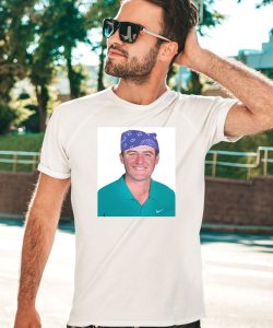 Scottie Scheffler High Fiving Fans Wearing Prison Mike Mugshot Shirt2